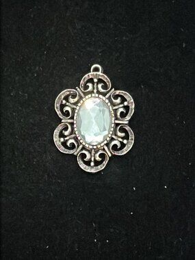 Clear Faceted Oval Stone in Silver Tone Scroll Frame Pendant